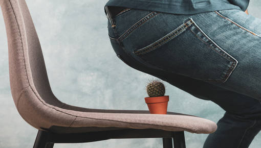 Hemorrhoid Treatment in Victoria, Texas A guy about to sit on a cactus simulating the pain of a hemorrhoid.